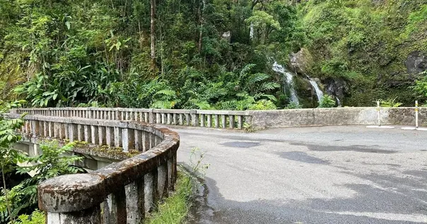 Historic concrete bridge and waterfall on the Famous Epic Road to Hana route