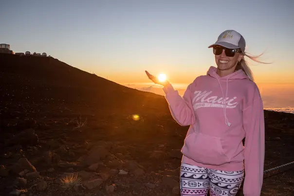 Guest posing with the sunset at Haleakala summit