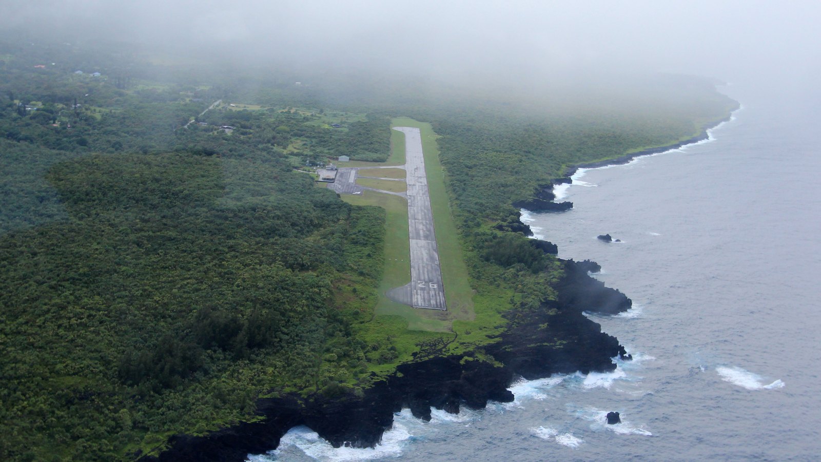 Aerial view of Hāna Airport runway beside the rugged East Maui lava coast