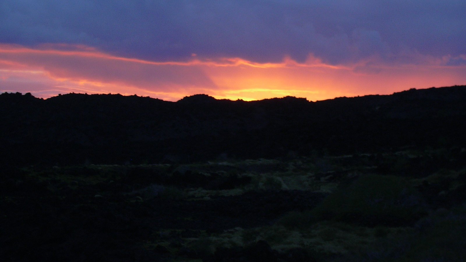 Sunset above the dark lava landscape at Kanaio on southeast Maui
