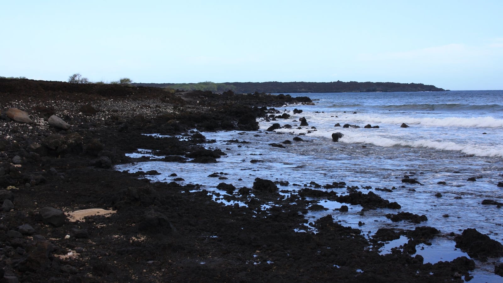 Black lava shoreline and blue water at Keoneʻōʻio on southwest Maui