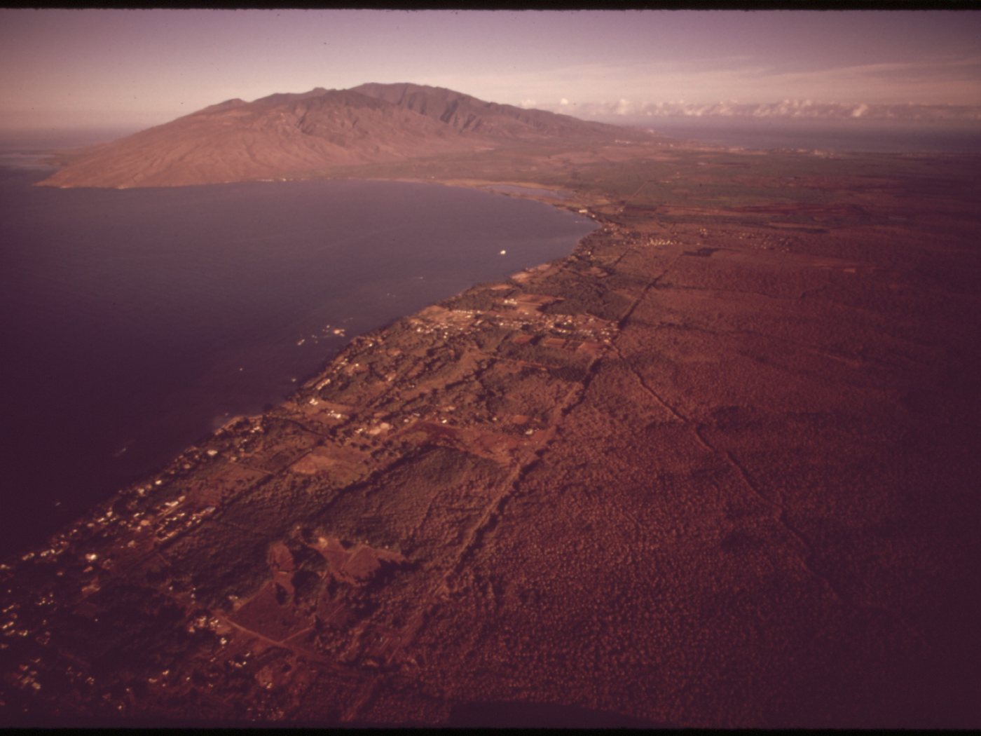 1973 aerial view of Māʻalaea Bay showing coastal settlement, agricultural fields, and West Maui