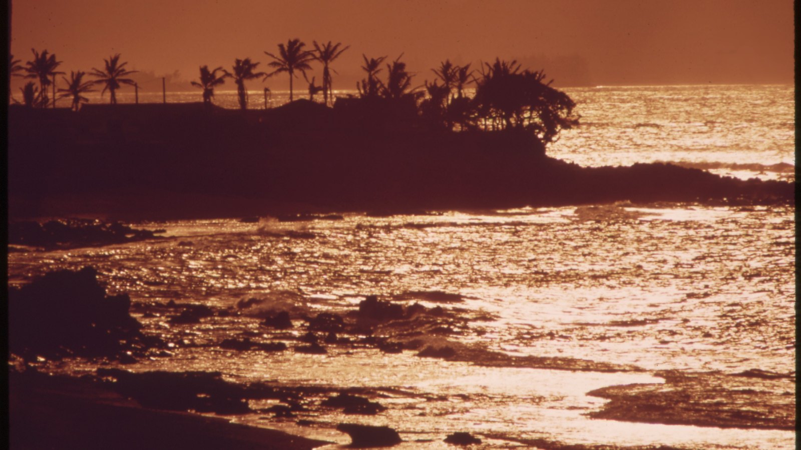 Late-afternoon surf entering narrow Māliko Bay in November 1973