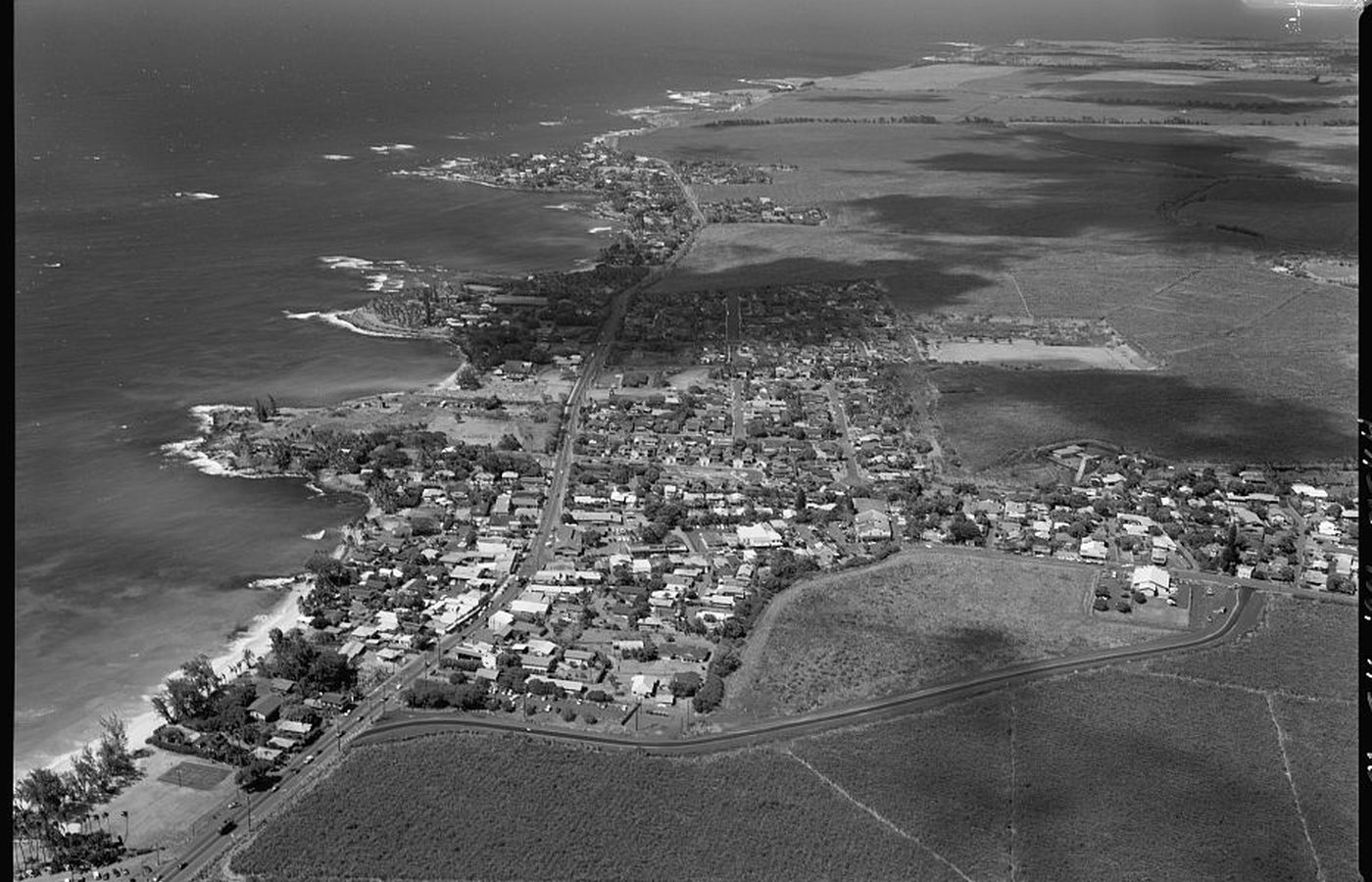 Historic American Engineering Record aerial showing Pāʻia town, its road grid, shoreline, and cane fields